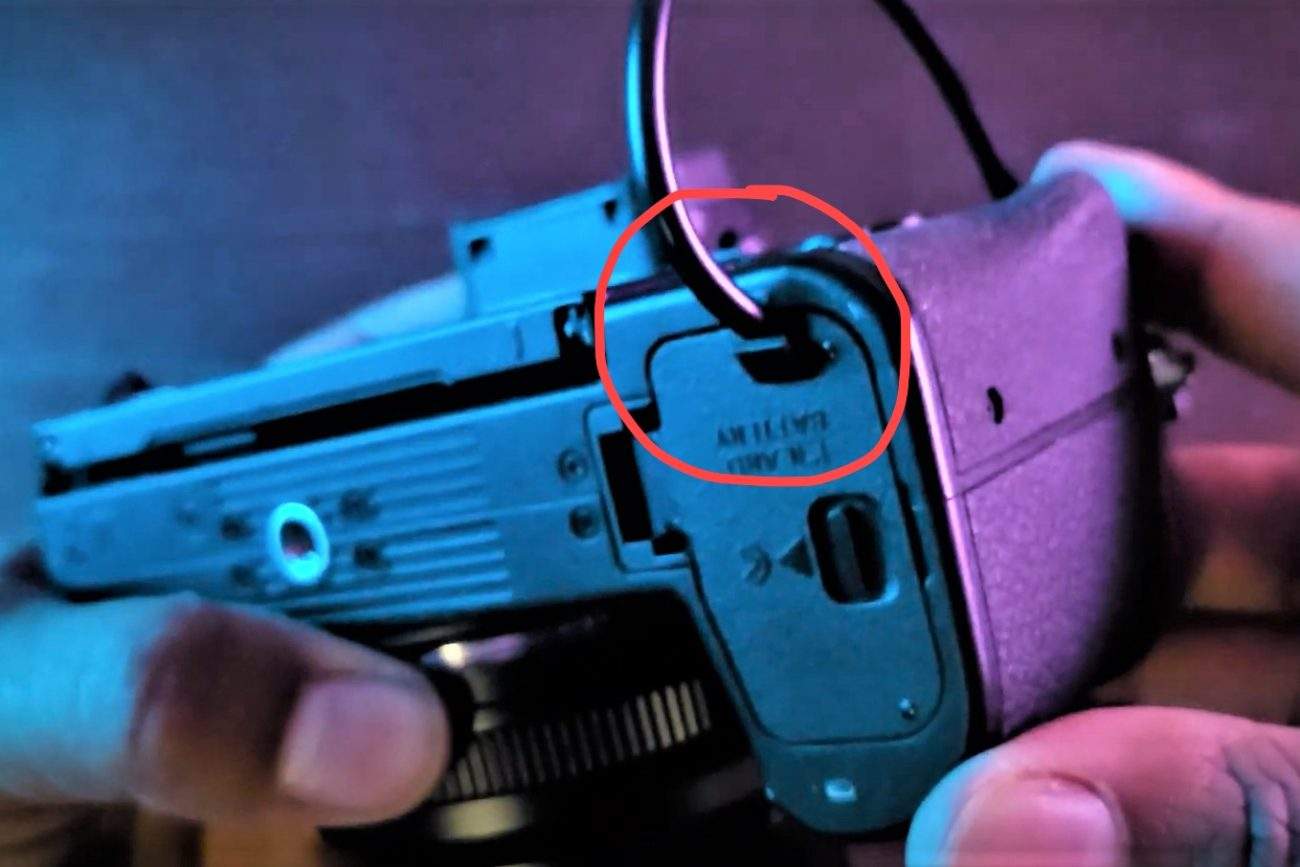 Nikon battery compartment wire slot